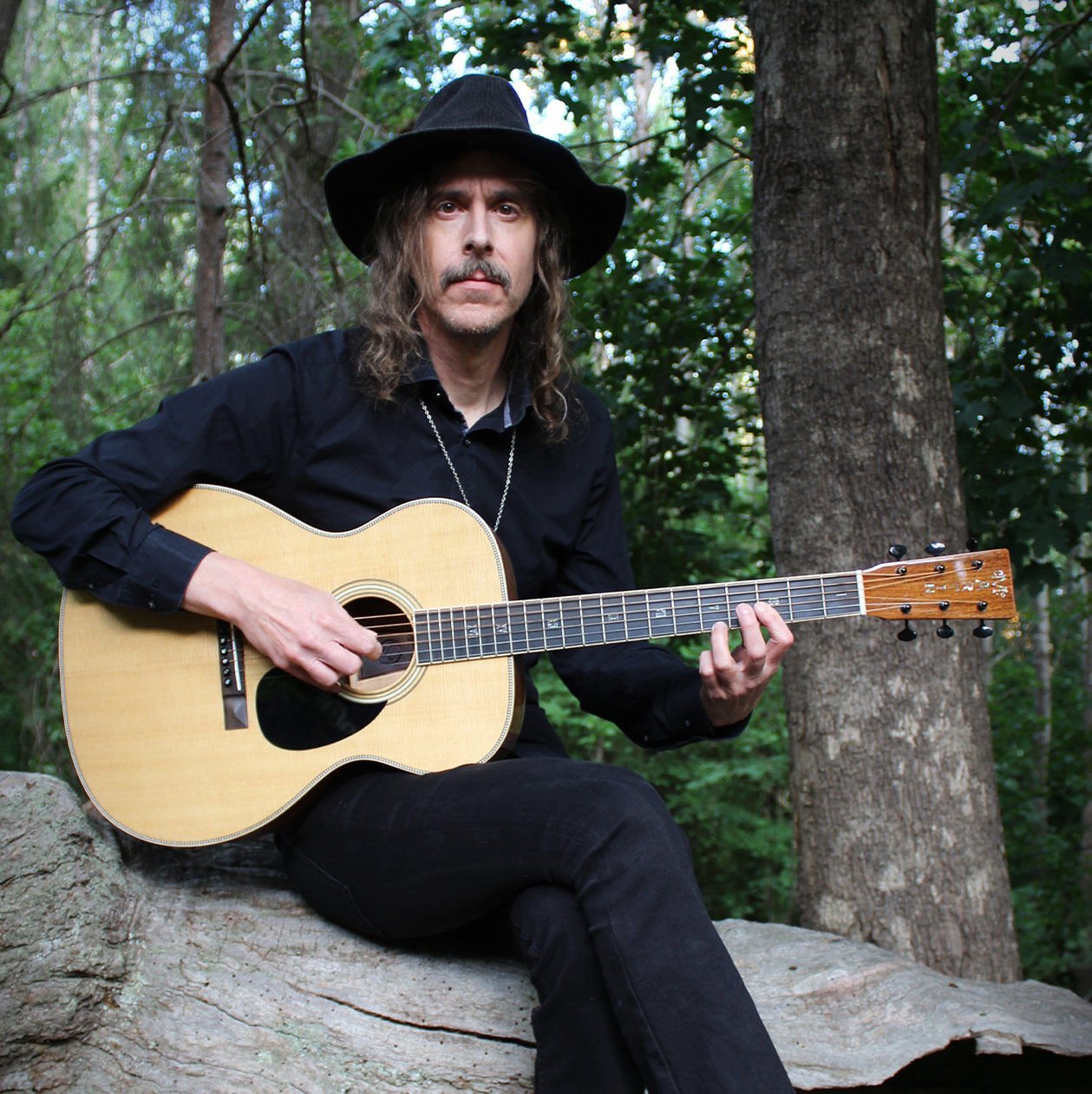 Mikael Akerfeldt sitting with his guitar